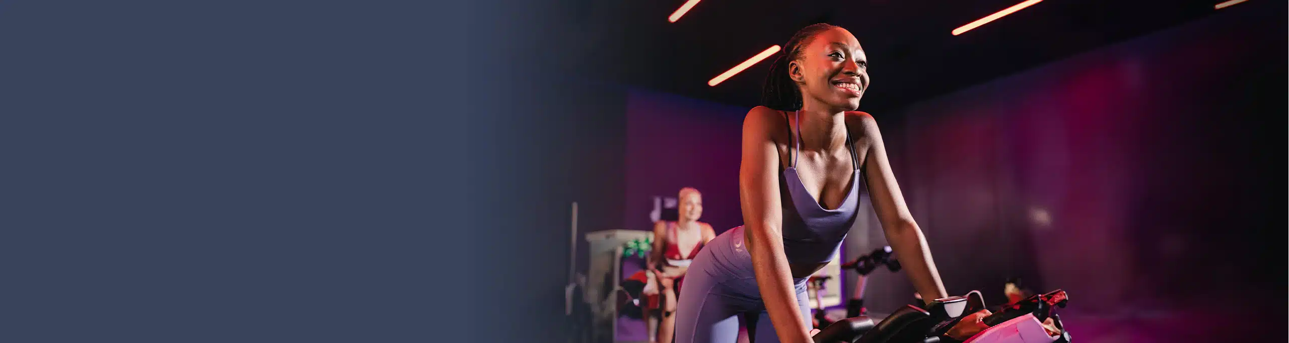A woman, who has a Virgin Active gym membership, stretches on an exercise mat at a Virgin Active gym.